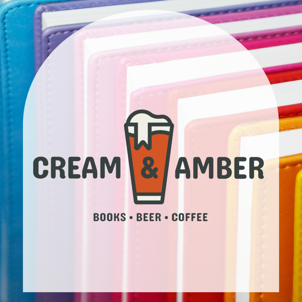 Picture of rainbow books with white arch in front if it that says "Cream & Amber, Books, Beer, Coffee"